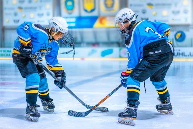 Two hockey players on rink